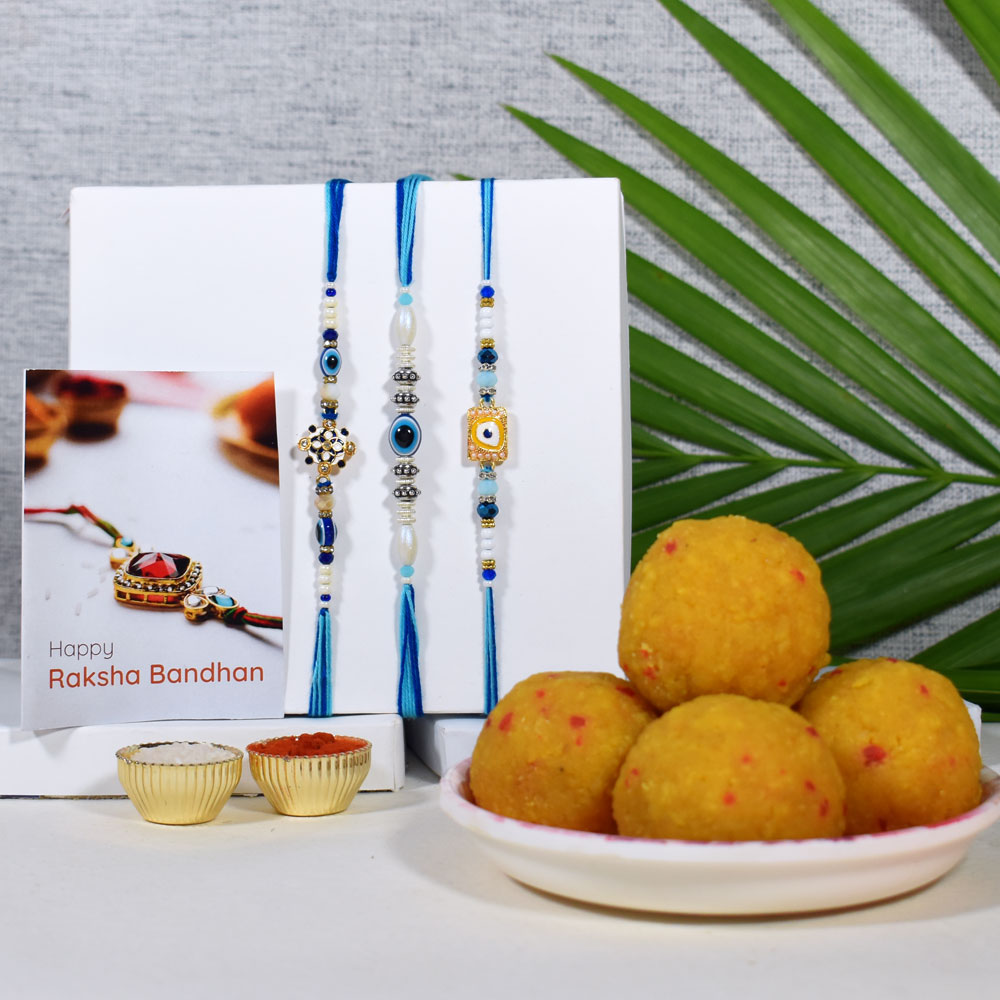 Designer Evil Eye Rakhi Set of 3 with Haldiram’s Kesar Laddu